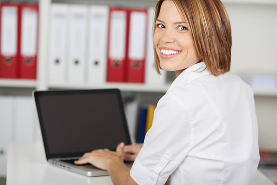 Smiling businesswoman with laptop computer
