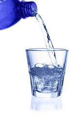 Pouring water on a glass on white background