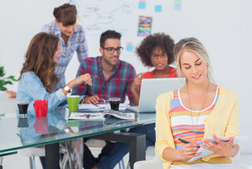 Pretty designer writing on a notepad