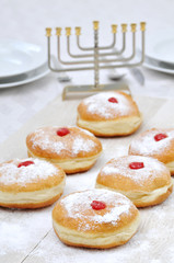 Hanukah doughnuts, sufganiya and menorah © gilya3