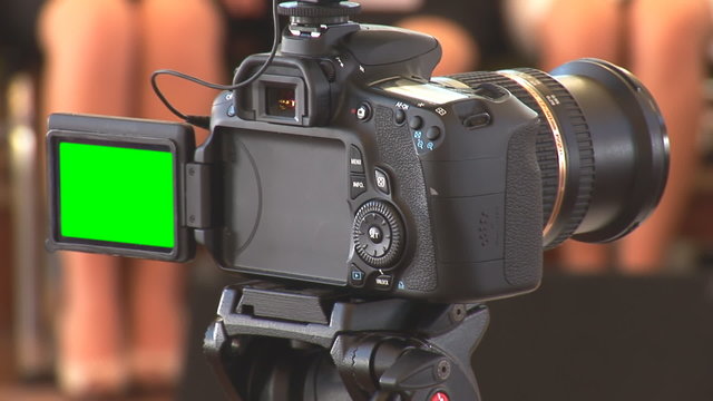 DSLR  camera in recording mode with green screen