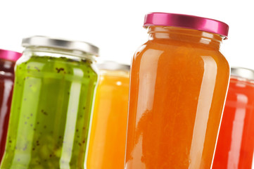 Jars of fruity jams isolated on white background
