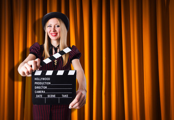 Woman gangster with movie clapper