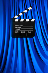Movie clapper board against curtain