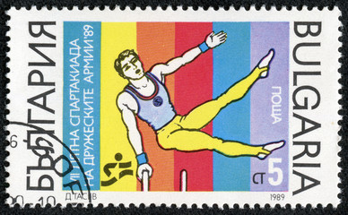 stamp printed in Bulgaria shows an athlete doing gymnastics