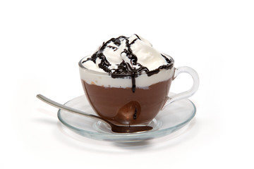 Hot chocolate with cream and syrup in glass cup