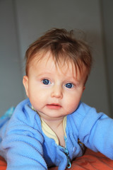 Charming blonde baby with blue eyes
