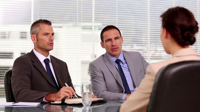 Businessmen talking to an applicant