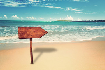 empty wooden signpost at tropical beach
