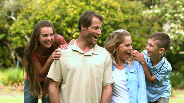 Smiling family spending time together in a park