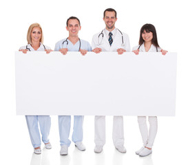 Group Of Doctors With Placard