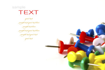 Group of colorful push pins on white background.