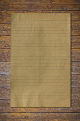 Fototapeta premium old paper on brown wood texture with natural patterns..