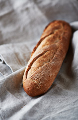 Fresh baguette on a linen cloth