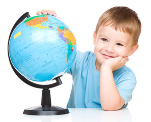 Happy little boy with a globe