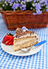 The piece of cake with cream and chocolate topping