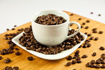 beans of  coffee and cup on the plate