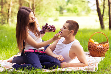 woman feeding man grapes
