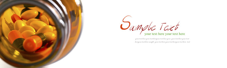 Pills, Tablets and Capsules spilled from a bottle on white backg