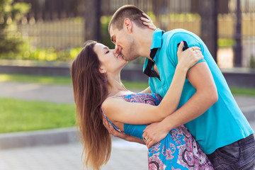 kissing young family