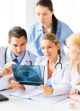 Young Group Of Doctors Looking At X-ray