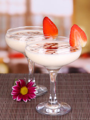 Fruit smoothies on table on window background