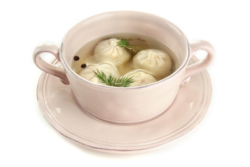 Tasty khinkali in .saucepan, isolated on white