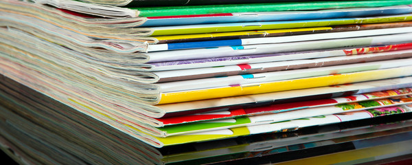 Many magazines on dark background