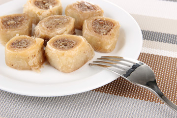 Sweet baklava on plate on table