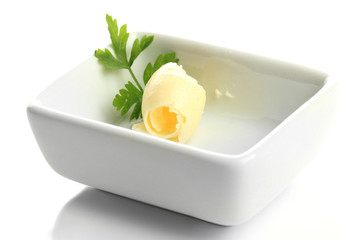 Butter curl on plate, isolated on white
