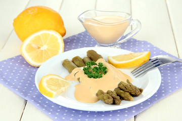 Asparagus on plate, on wooden background