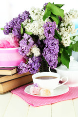 Composition with beautiful lilac flowers, tea service