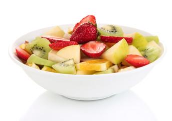 Useful fruit salad of fresh fruits and berries in bowl isolated