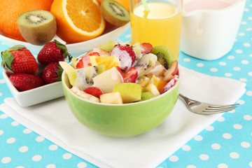 Useful fruit salad of fresh fruits and berries in bowl