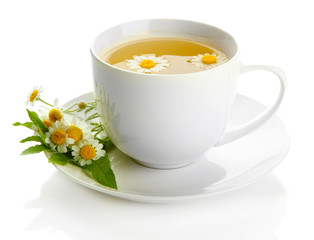 Cup of herbal tea with wild camomiles and mint, isolated