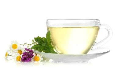 Cup of herbal tea with wild flowers and mint, isolated on white