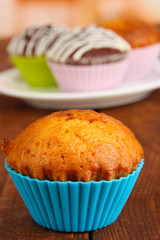Sweet cupcakes on wooden table