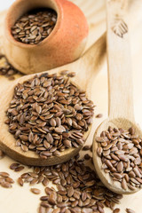 close up of flax seeds in a wooden spoon
