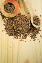 close up of flax seeds in a wooden spoon