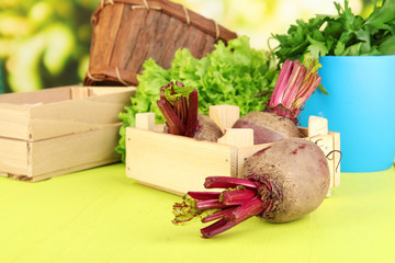 Young beets on wooden box on wooden table close-up