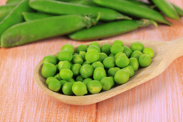 Sweet green peas on wooden background