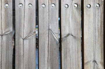 Weathered boards and bolts of wooden fence