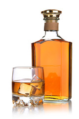 Glass of brandy and bottle isolated on white