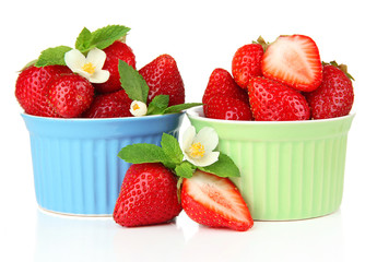 Ripe sweet strawberries in bowls, isolated on white
