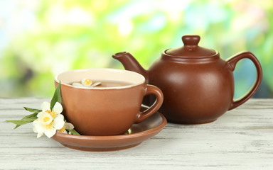 Cup of tea with jasmine, on bright background