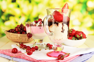 Delicious strawberry and cherry desserts in glass vase