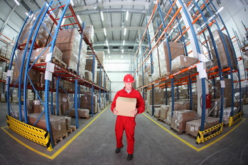 worker in red uniform with box in the warehouse in fish-eye lens