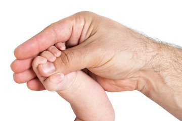 Little baby hand holding father's thumb
