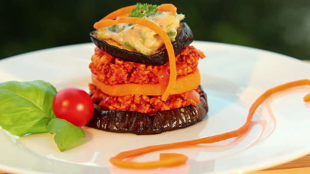 Vegan moussaka: tofu eggplant sweet potato tomato - dolly shot