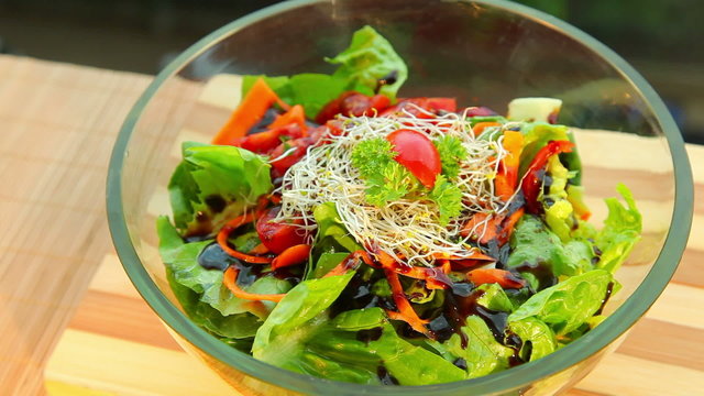 Fresh vegetable salad with dressing - dolly shot